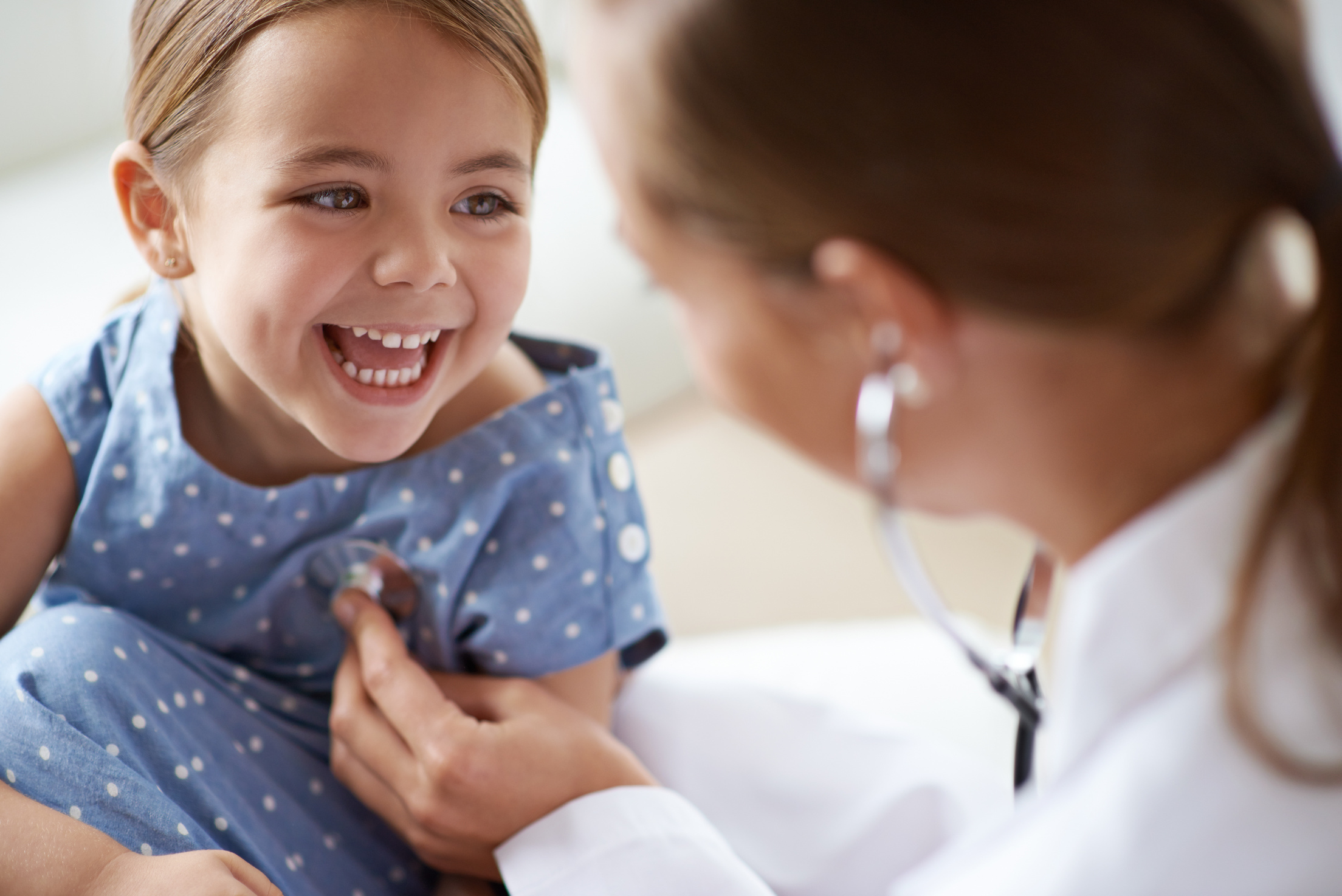 Happy Child, Girl and Stethoscope of Doctor for Medical Consulting, Healthy Lungs and Listening to Heartbeat. Face of Laughing Kid, Pediatrician and Chest Assessment for Healthcare Analysis in Clinic