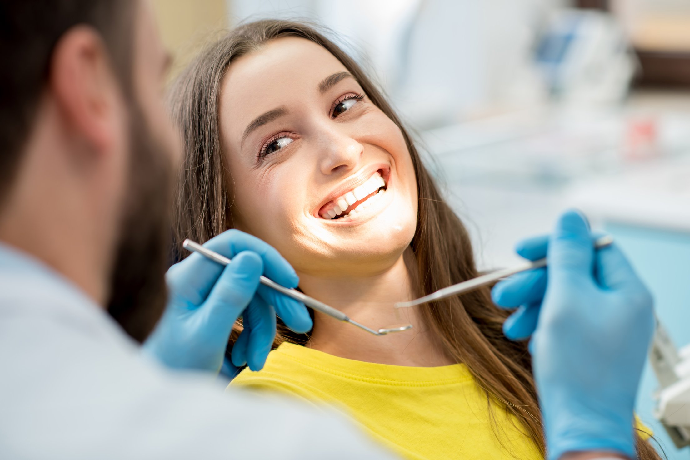 Happy female patient at the dental office